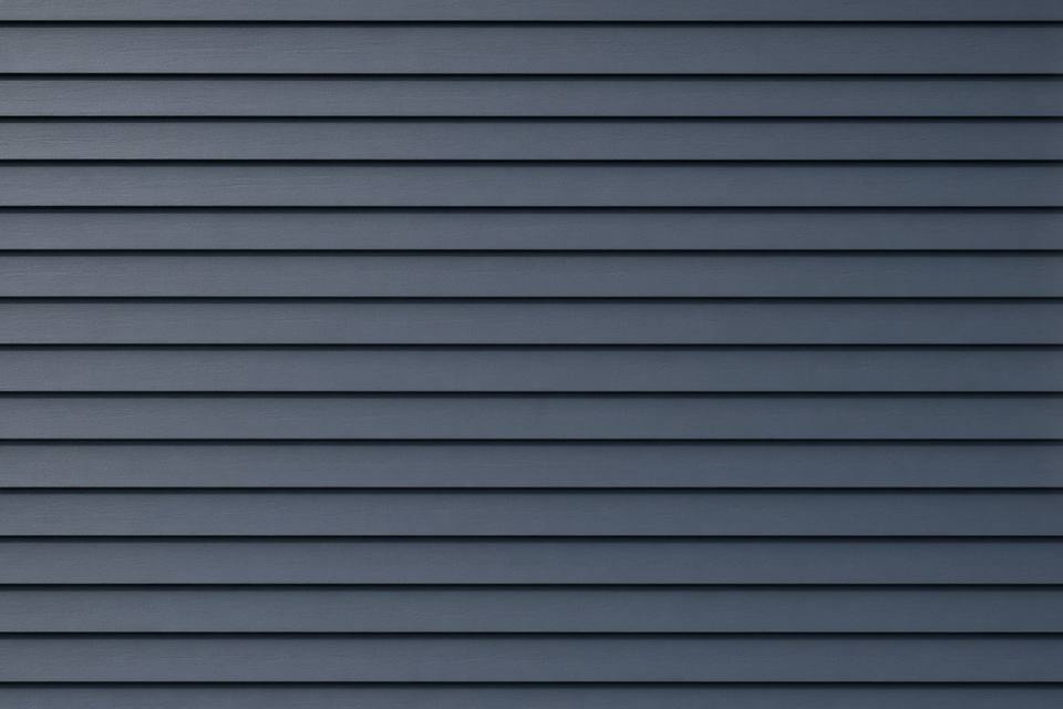 Blue-gray lap siding courses on a flat wall